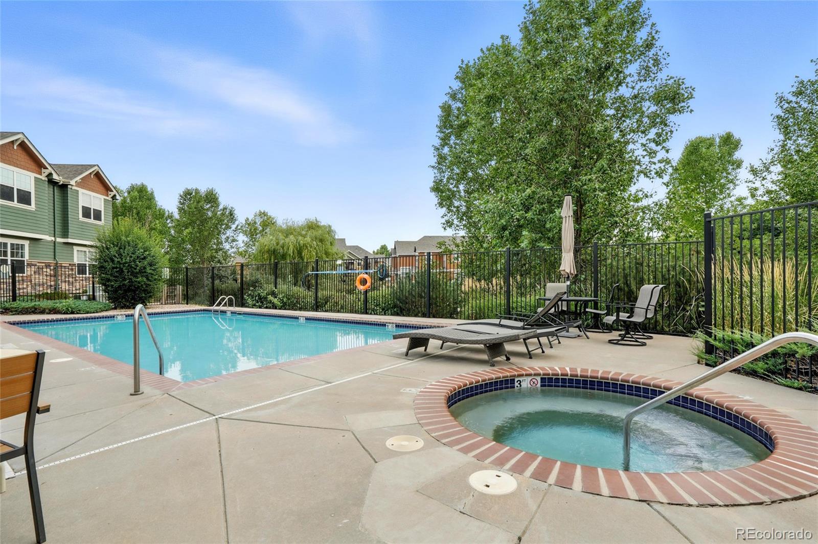 7080 Simms Street, Unit 204 Arvada, CO 80004 - Photo 40 of 49 a view of a swimming pool with a patio and a yard