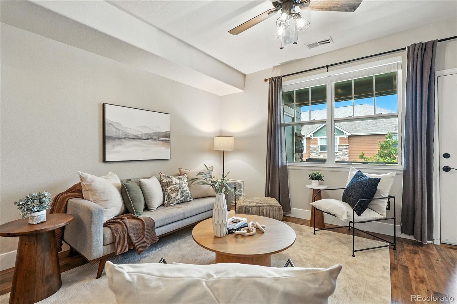 7080 Simms Street, Unit 204 Arvada, CO 80004 - Photo 5 of 49 a living room with furniture and a table