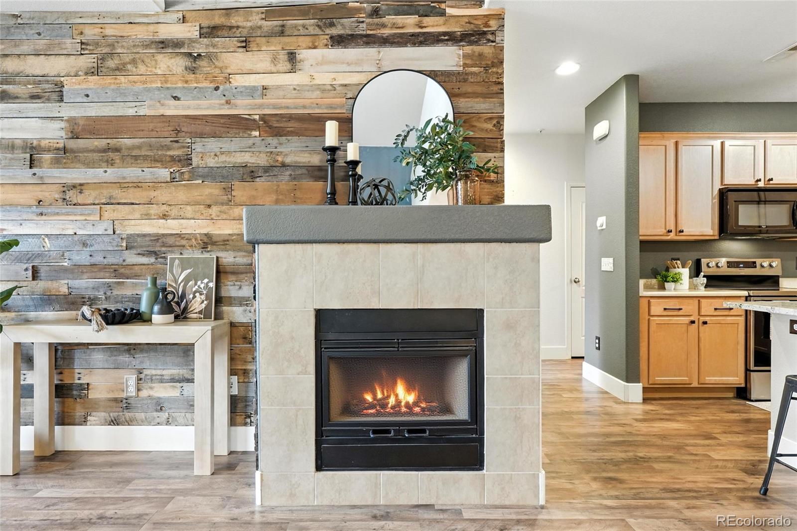 7080 Simms Street, Unit 204 Arvada, CO 80004 - Photo 8 of 49 a living room with furniture and a fireplace