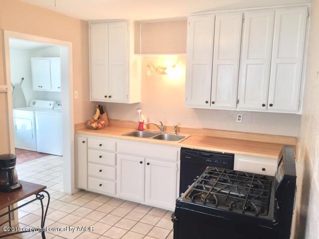4219 South Ong Street Amarillo, TX 79110 - Photo 11 of 24 a kitchen with stainless steel appliances granite countertop a stove and a refrigerator