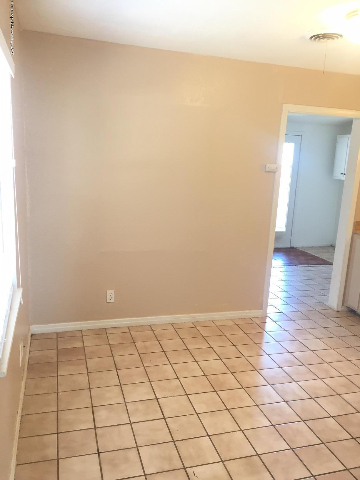 4219 South Ong Street Amarillo, TX 79110 - Photo 12 of 24 a view of an empty room and wooden floor