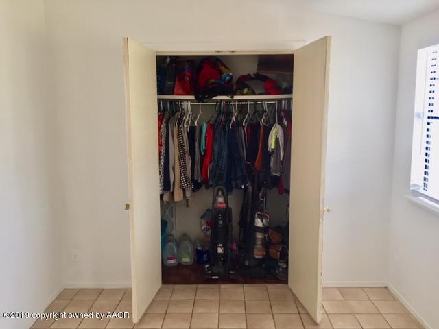 4219 South Ong Street Amarillo, TX 79110 - Photo 15 of 24 a view of walk in closet with clothes and shoes