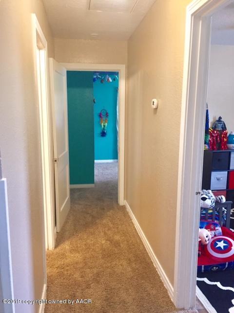 4219 South Ong Street Amarillo, TX 79110 - Photo 17 of 24 a view of a hallway to rooms and a potted plant
