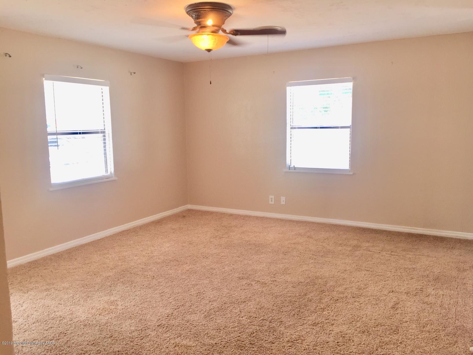 4219 South Ong Street Amarillo, TX 79110 - Photo 4 of 24 an empty room with windows