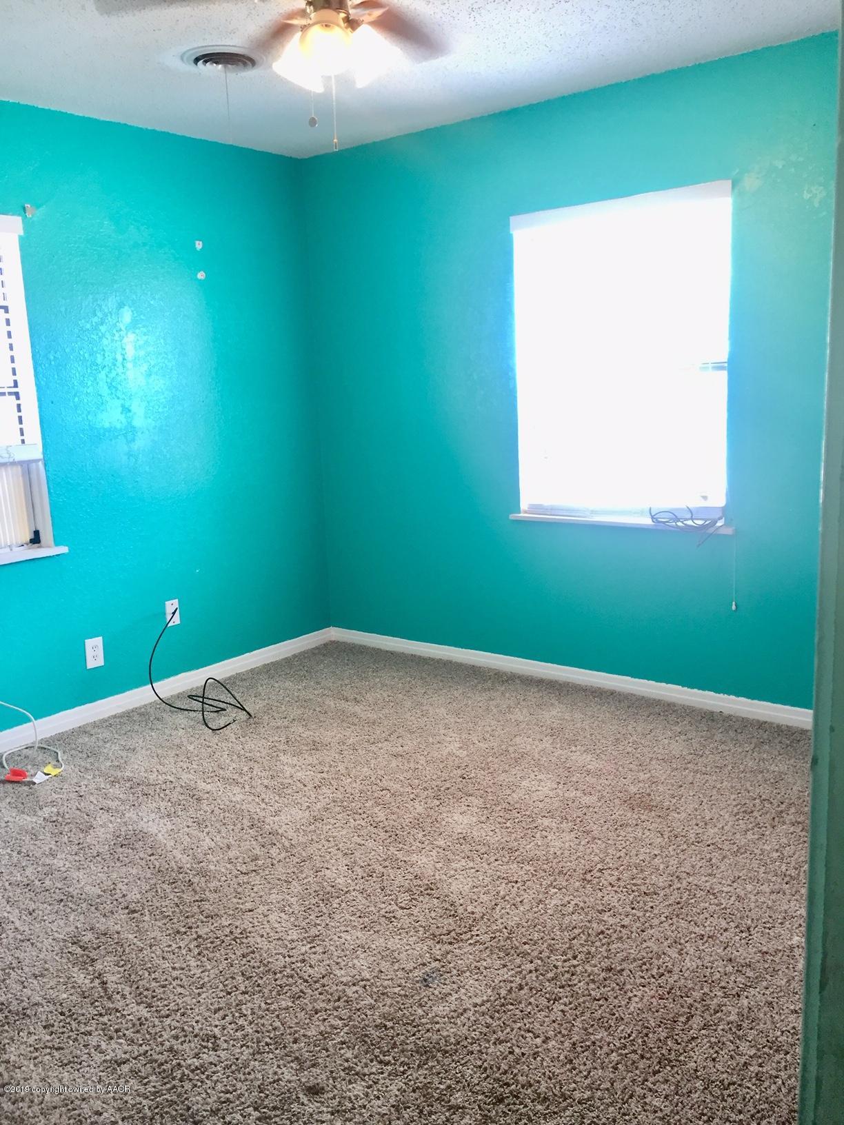 4219 South Ong Street Amarillo, TX 79110 - Photo 7 of 24 a view of a room with a window and a ceiling fan