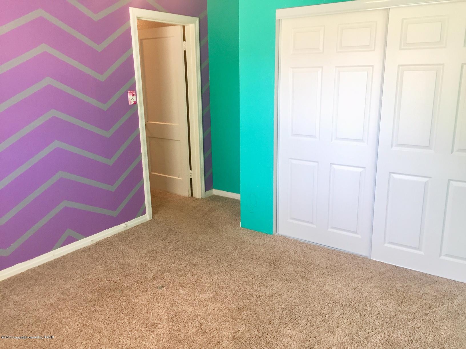 4219 South Ong Street Amarillo, TX 79110 - Photo 8 of 24 an empty room with a door