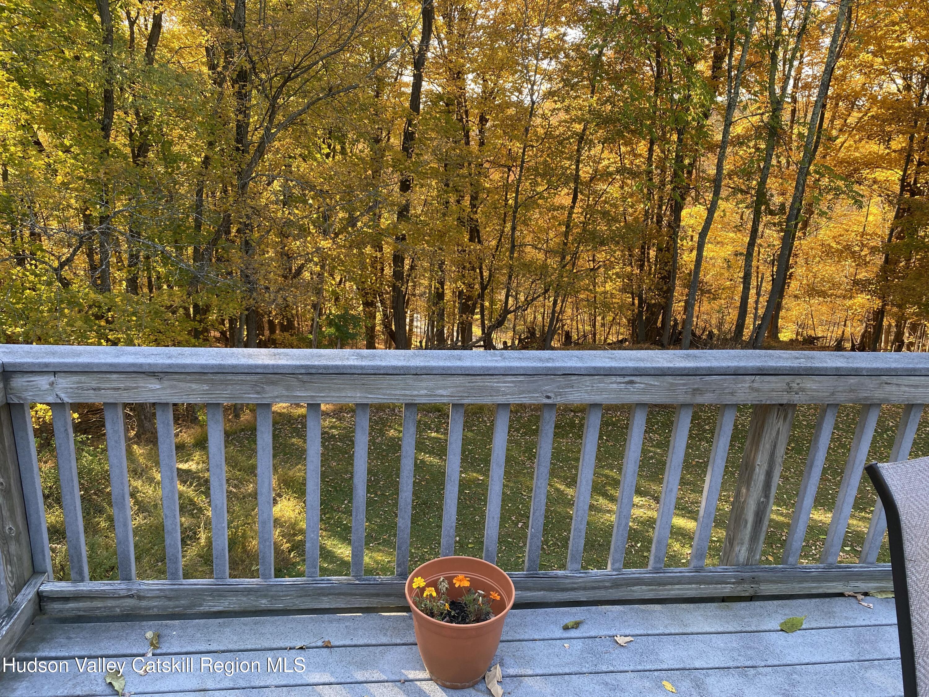 22 Beacham Road Rhinebeck, NY 12572 - Photo 21 of 38 a porch with a bench