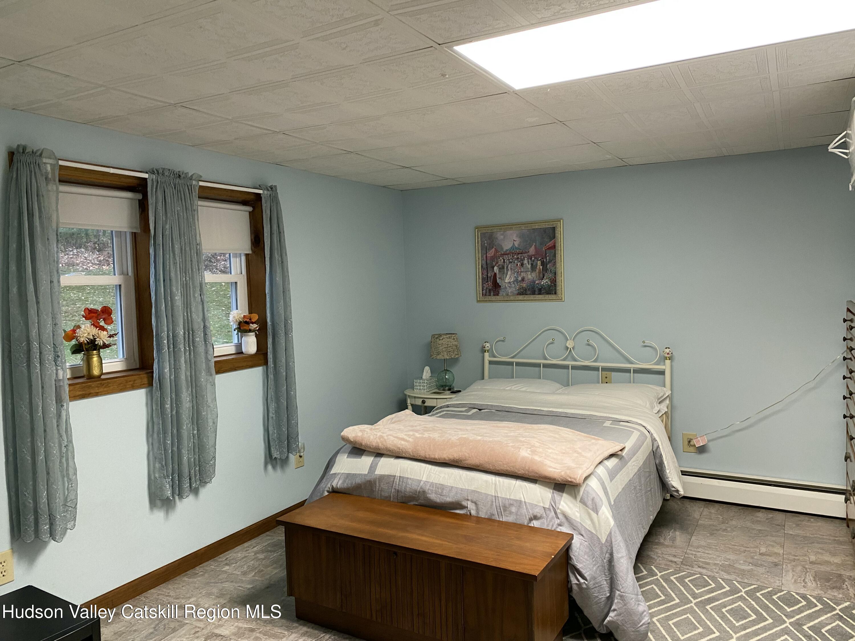 22 Beacham Road Rhinebeck, NY 12572 - Photo 27 of 38 a bed sitting in a bedroom next to a window