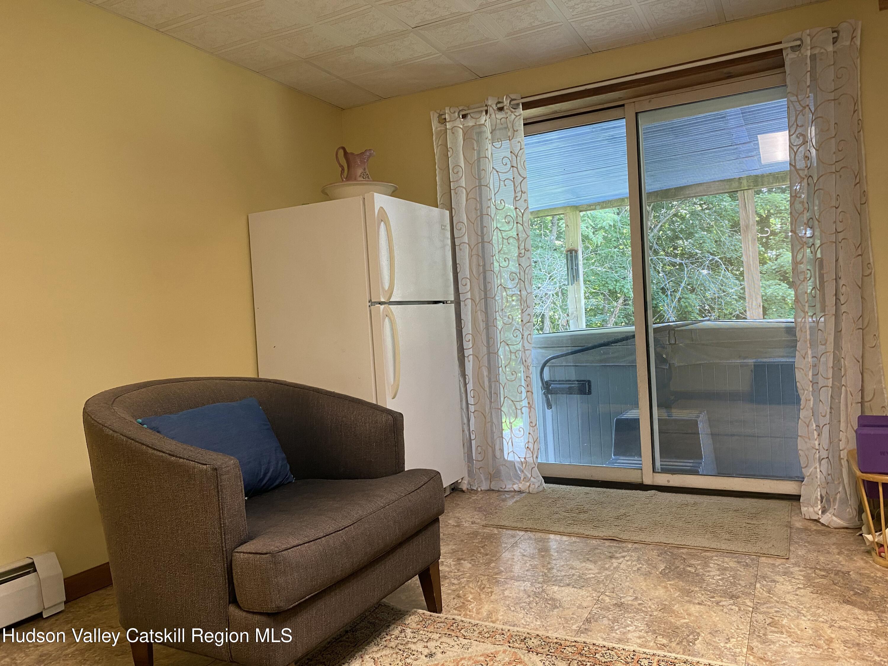 22 Beacham Road Rhinebeck, NY 12572 - Photo 32 of 38 a living room with furniture and a window