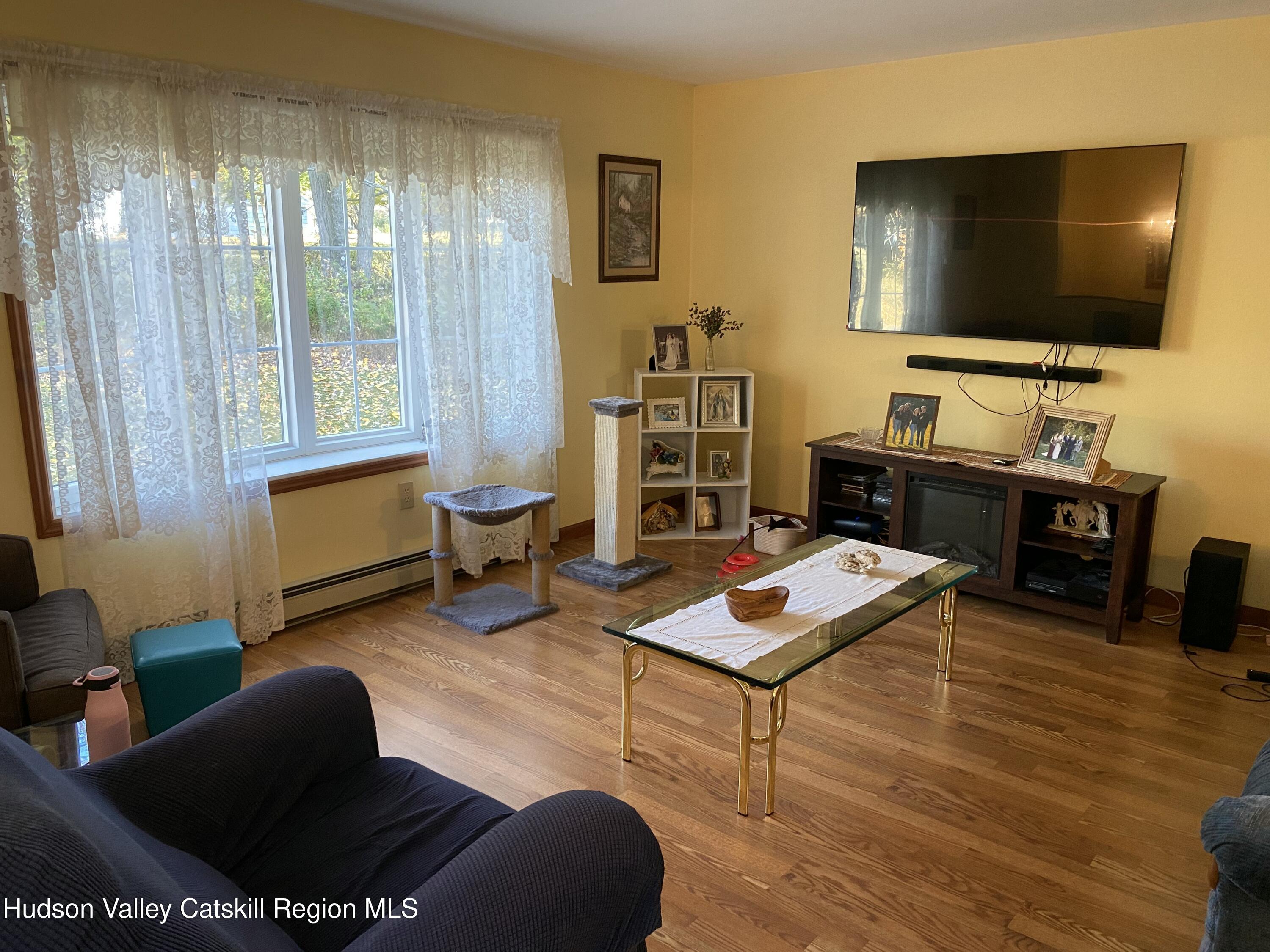 22 Beacham Road Rhinebeck, NY 12572 - Photo 5 of 38 a living room with furniture and a flat screen tv