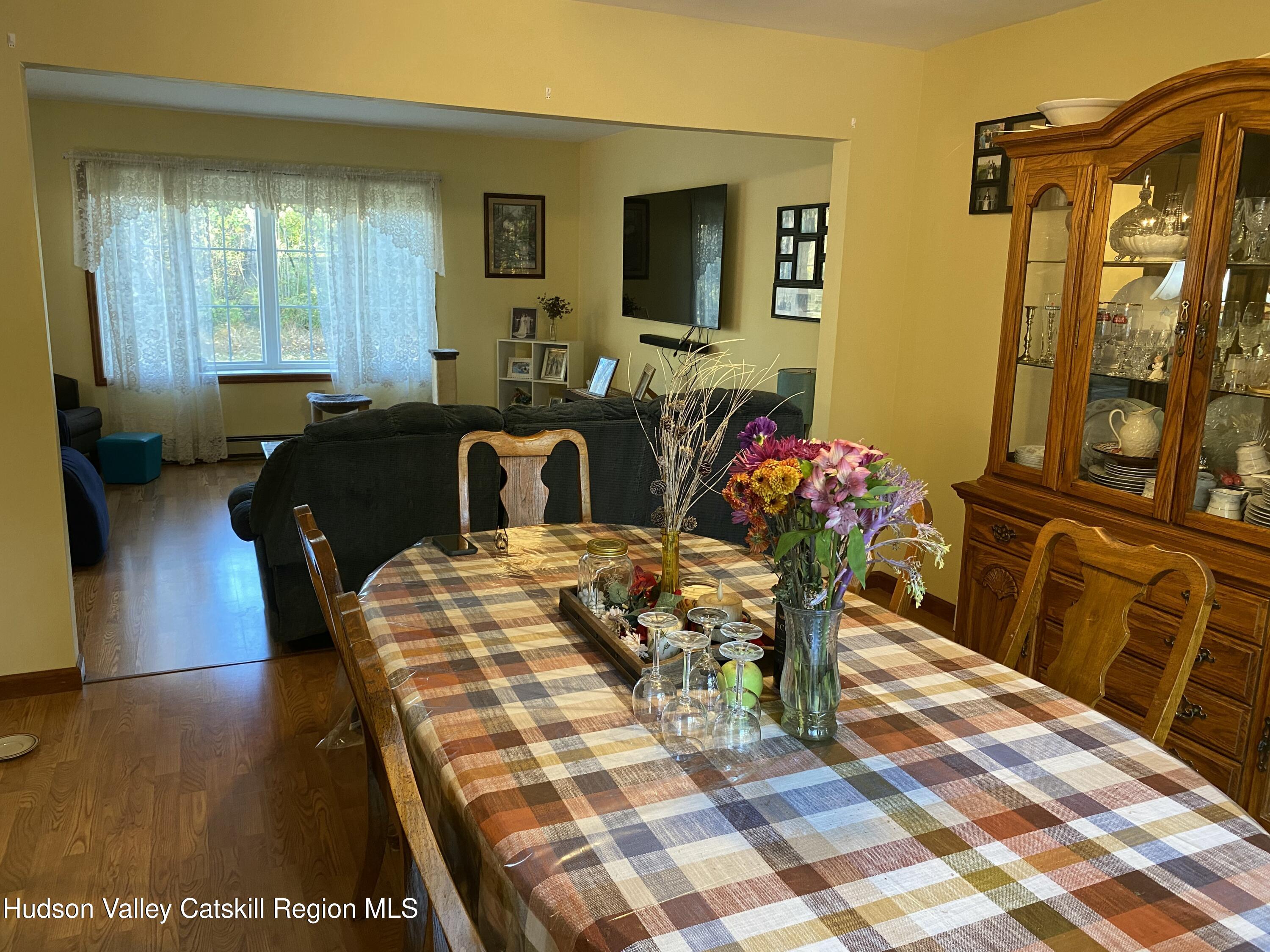 22 Beacham Road Rhinebeck, NY 12572 - Photo 6 of 38 a view of a dining room with furniture and wooden floor