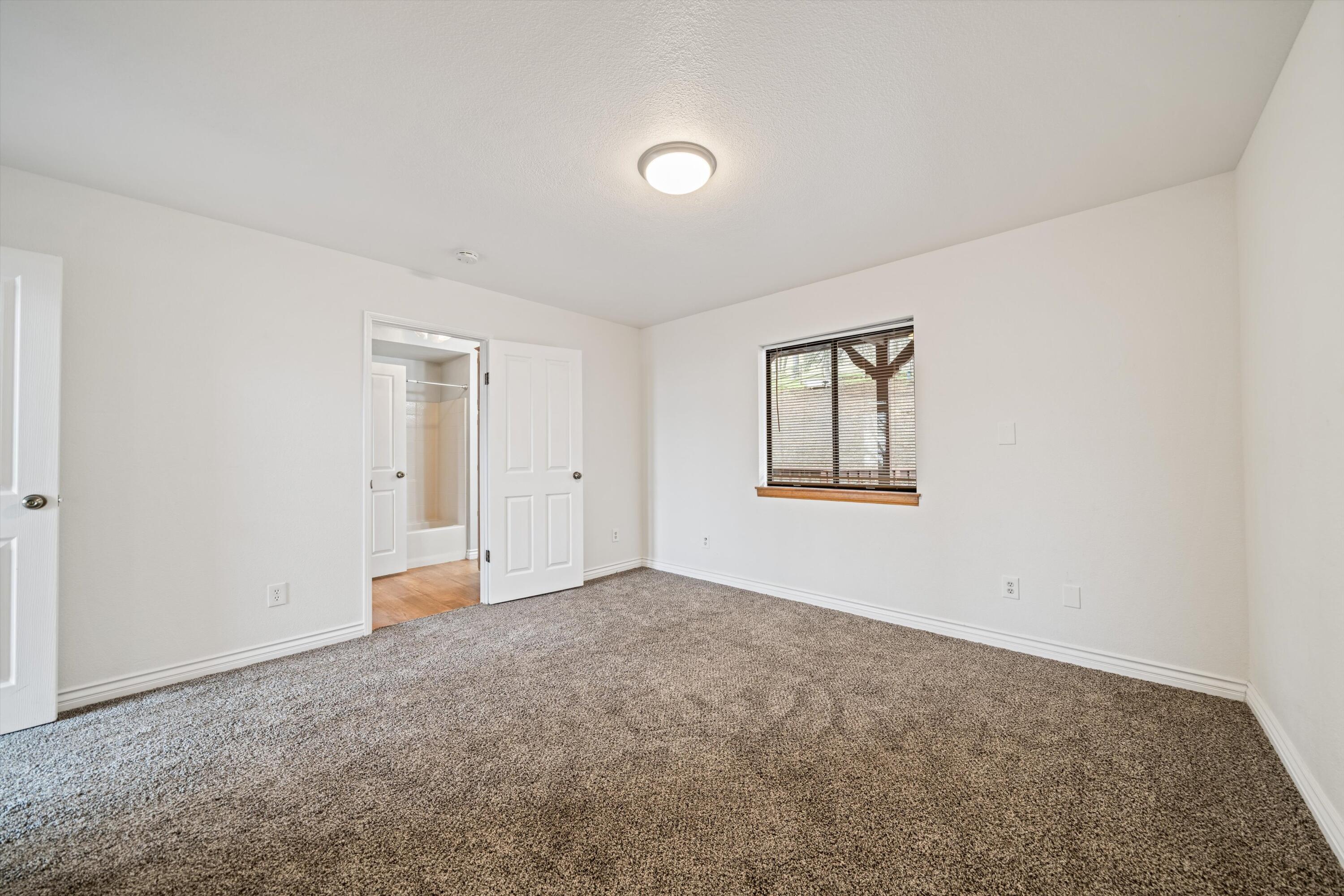 18249 Alps Drive Tehachapi, CA 93561 - Photo 25 of 32 an empty room with windows and closet