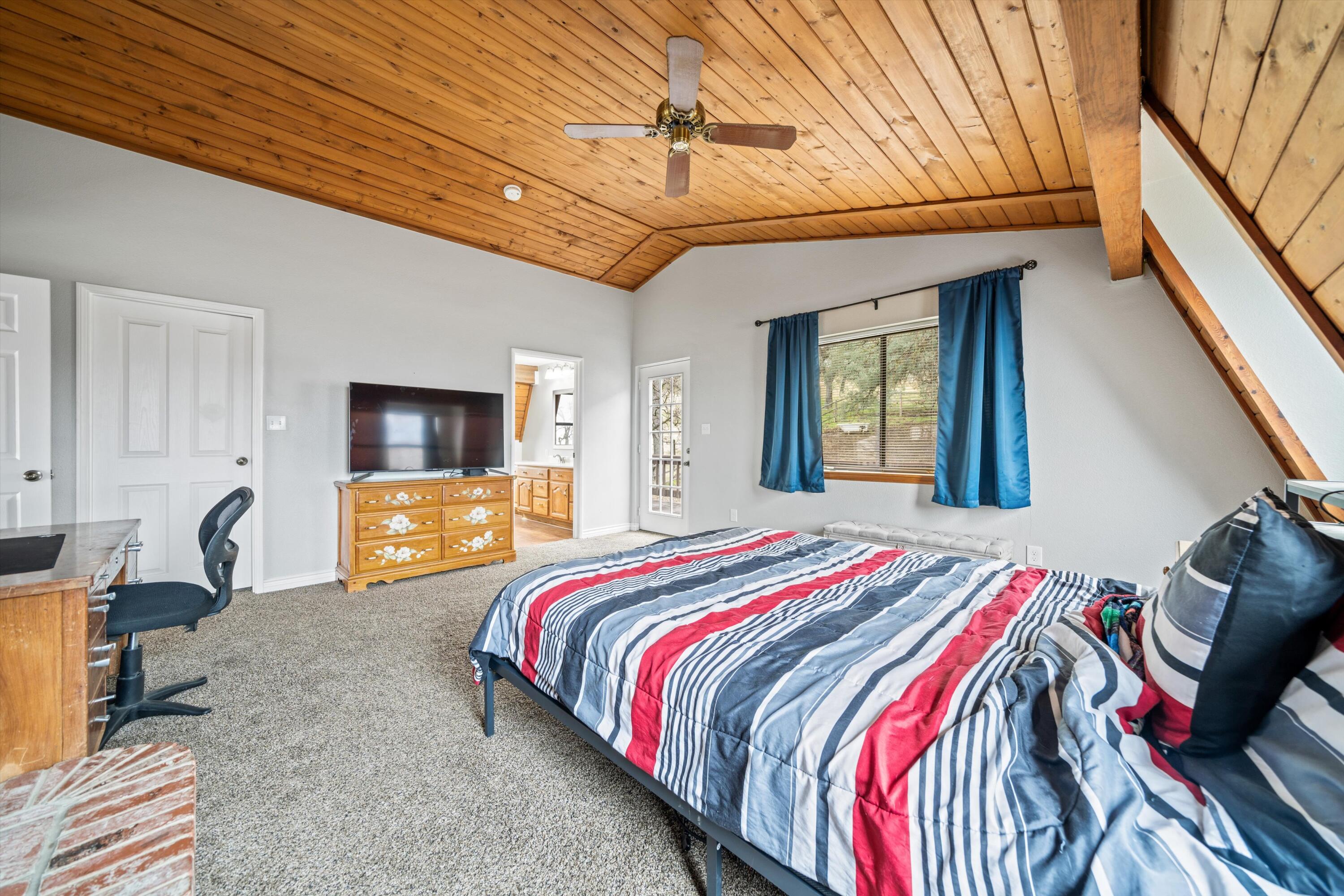 18249 Alps Drive Tehachapi, CA 93561 - Photo 32 of 32 a bedroom with a bed a flat screen tv and balcony