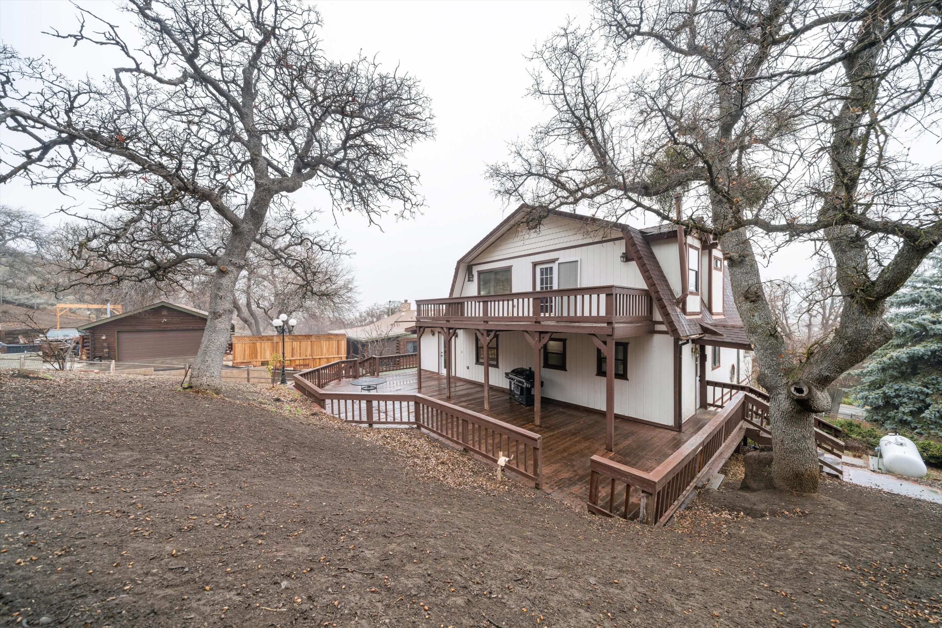 18249 Alps Drive Tehachapi, CA 93561 - Photo 5 of 32 a view of a house with a bench and wooden fence