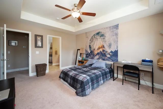 a bedroom with a bed and a chandelier