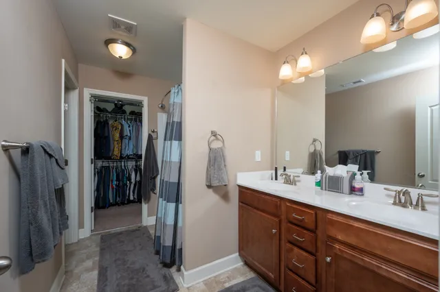 a bathroom with a double vanity sink and a mirror