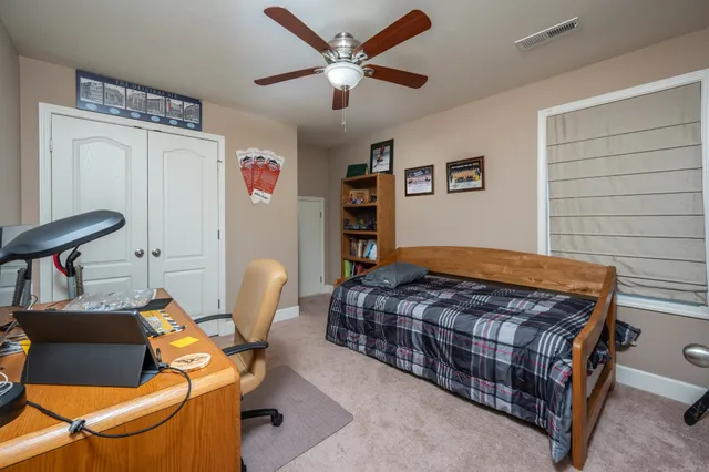 a bedroom with a bed and a chair in it