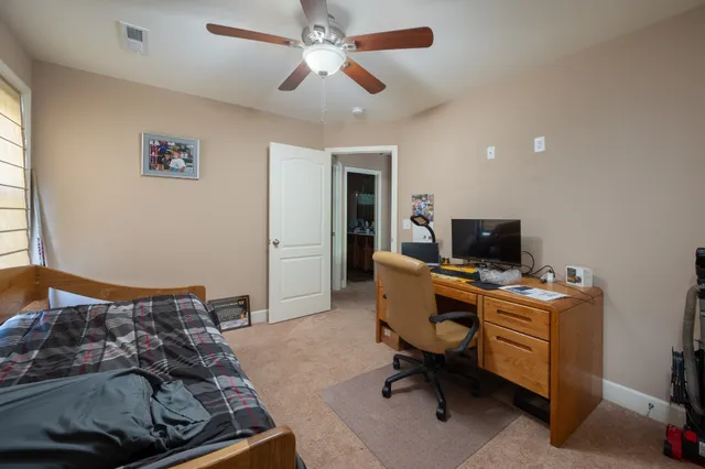 a bedroom with a workspace