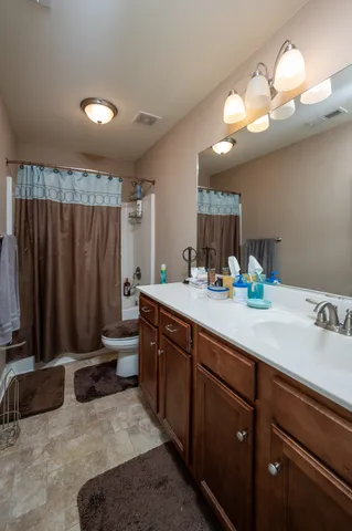 a bathroom with a double vanity sink and a mirror
