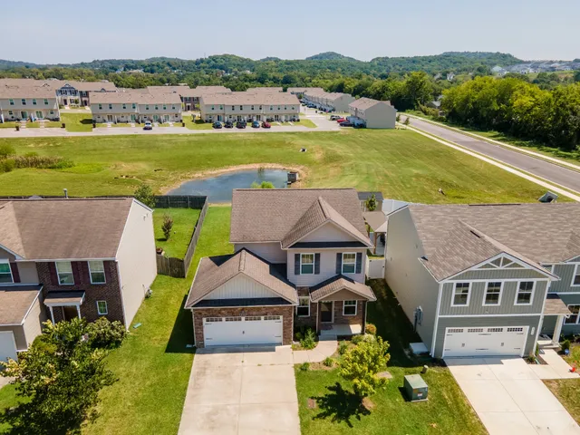 an aerial view of a house with a big yard