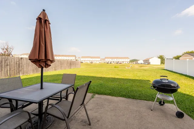 a view of a lake with a table and chairs