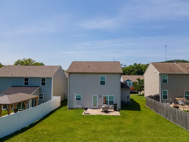 a view of a house with backyard porch and furniture