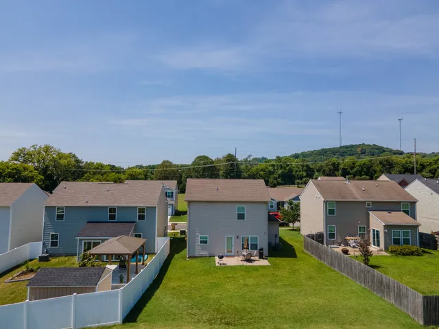 a front view of house with yard and car parked