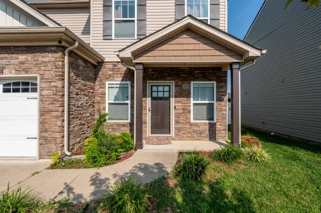 a front view of a house with garden