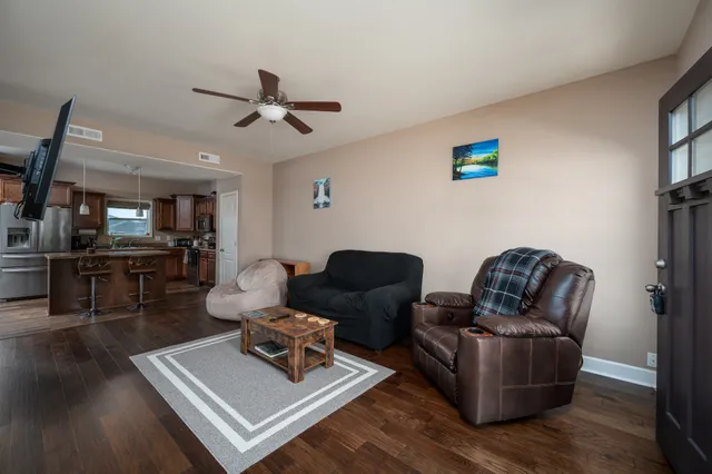 a living room with furniture and wooden floor