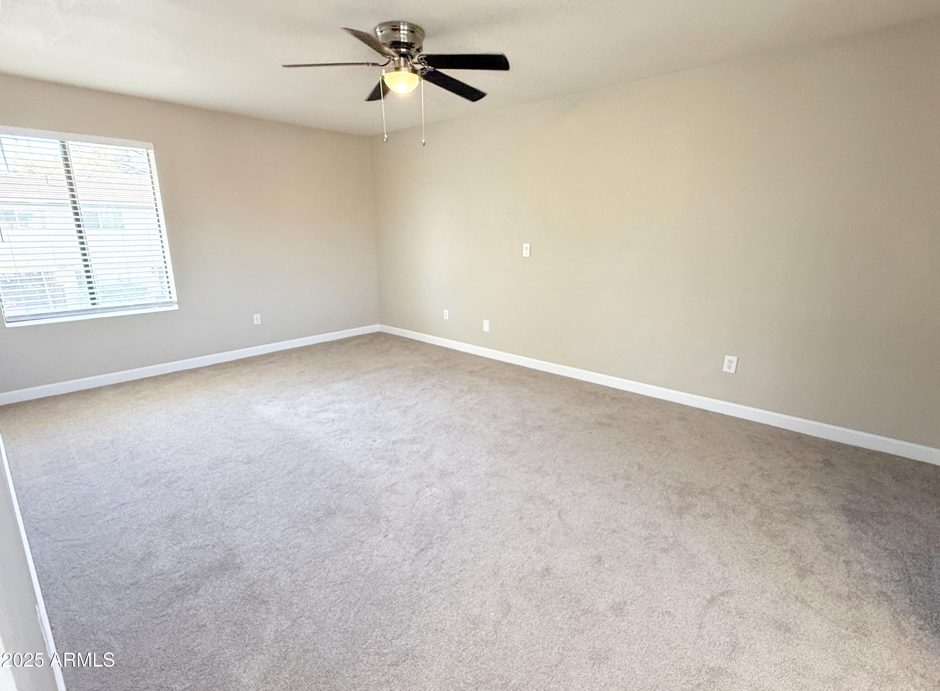 1529 East Edgewater Drive Tempe, AZ 85283 - Photo 11 of 34 an empty room with windows and fan