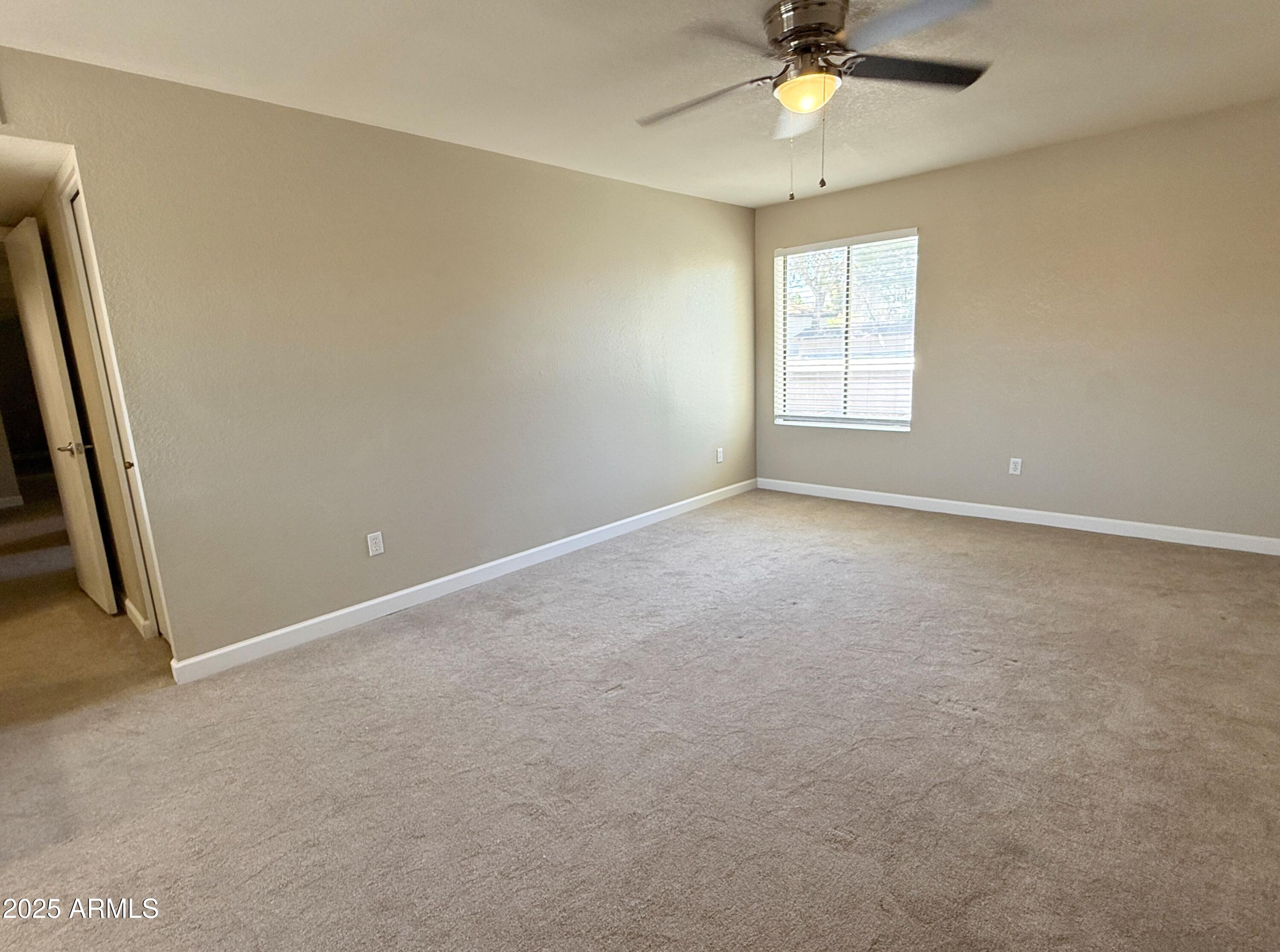 1529 East Edgewater Drive Tempe, AZ 85283 - Photo 12 of 34 an empty room with a window and a fan