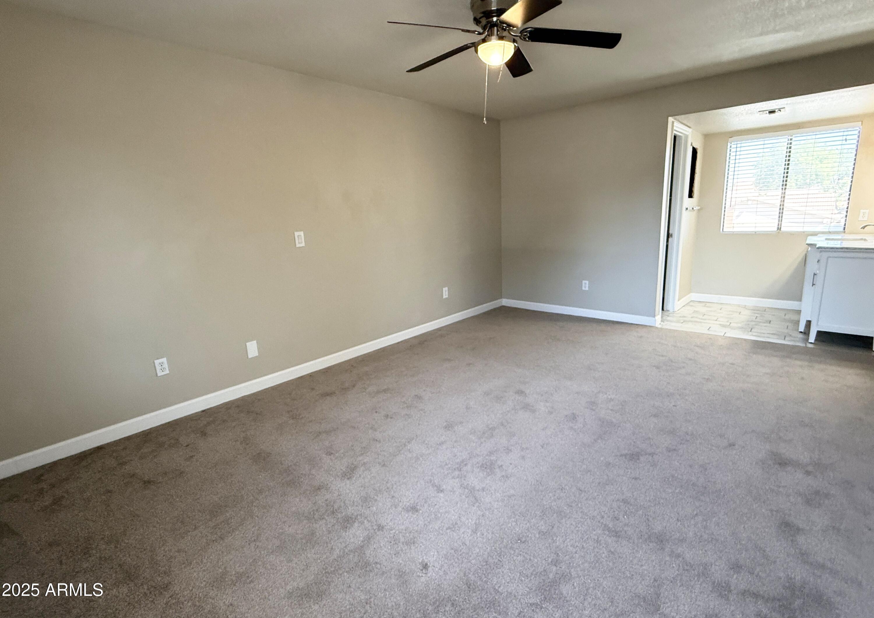 1529 East Edgewater Drive Tempe, AZ 85283 - Photo 14 of 34 an empty room with a ceiling fan and window