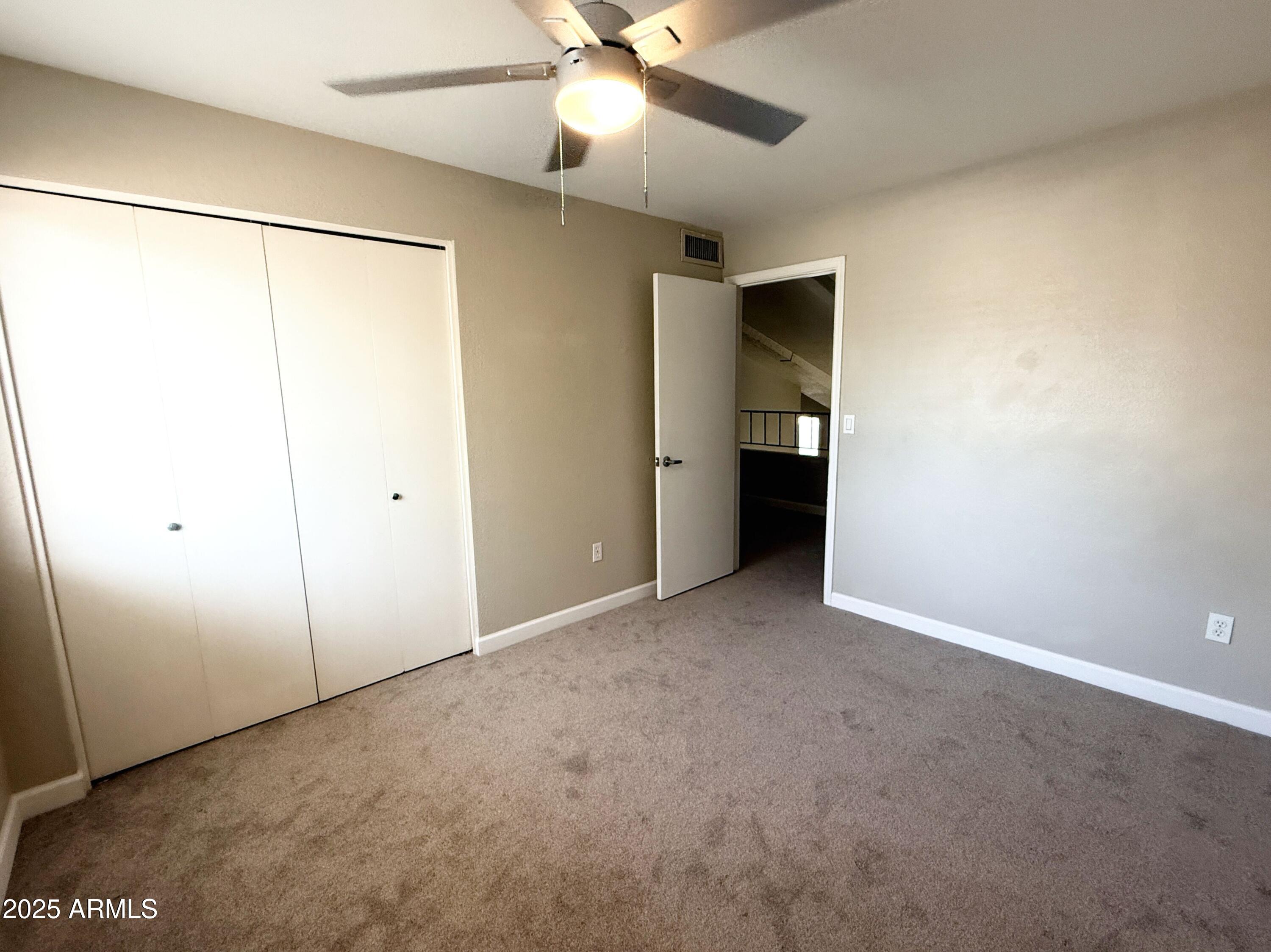 1529 East Edgewater Drive Tempe, AZ 85283 - Photo 22 of 34 an empty room with fan