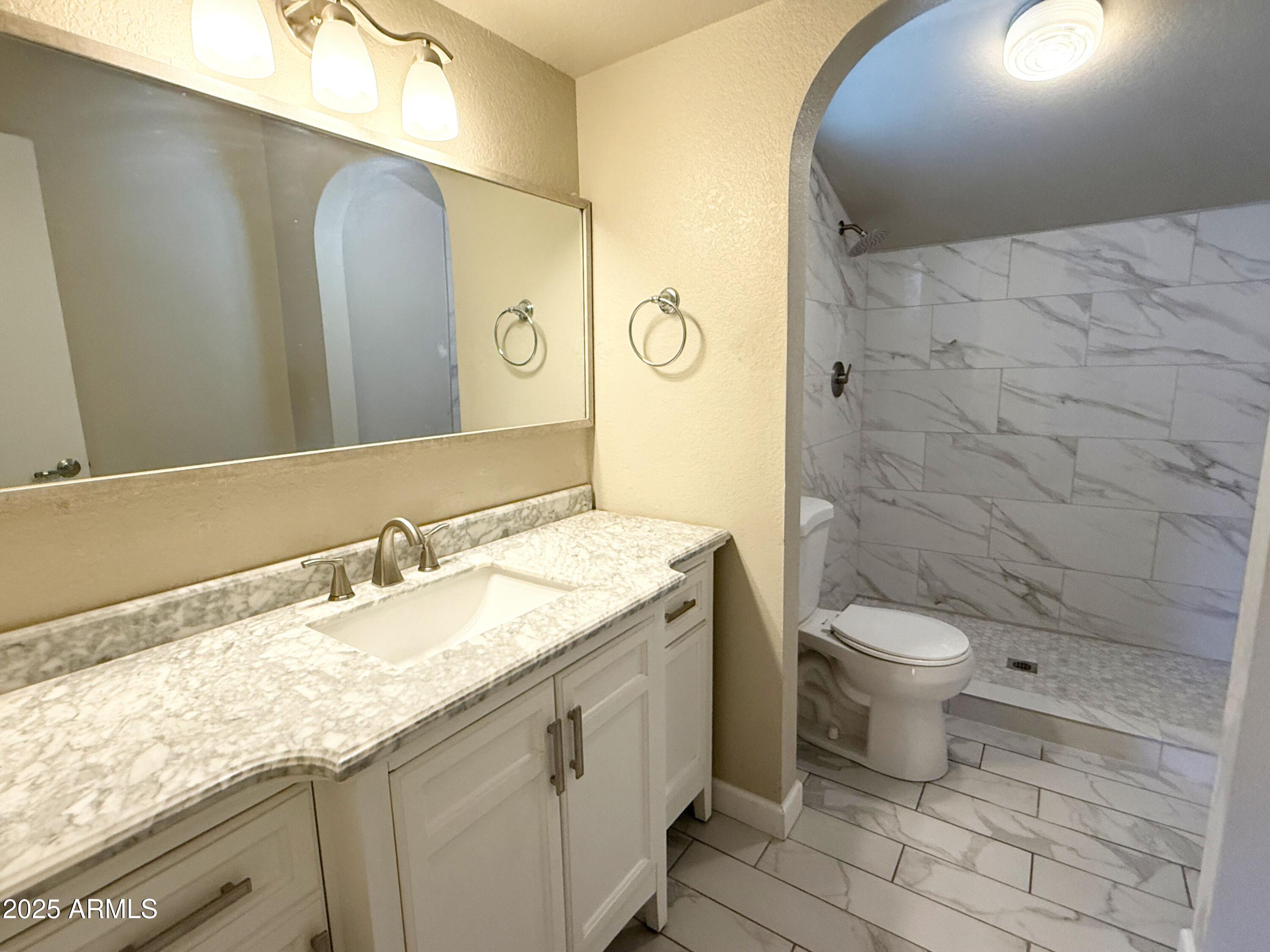 1529 East Edgewater Drive Tempe, AZ 85283 - Photo 24 of 34 a bathroom with a granite countertop sink toilet and shower