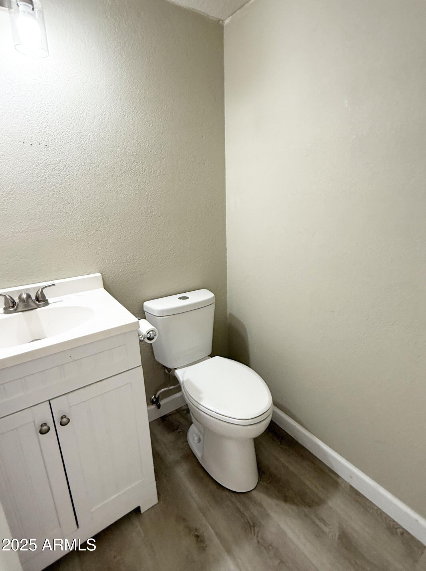 1529 East Edgewater Drive Tempe, AZ 85283 - Photo 26 of 34 a white toilet sitting next to a bathroom sink