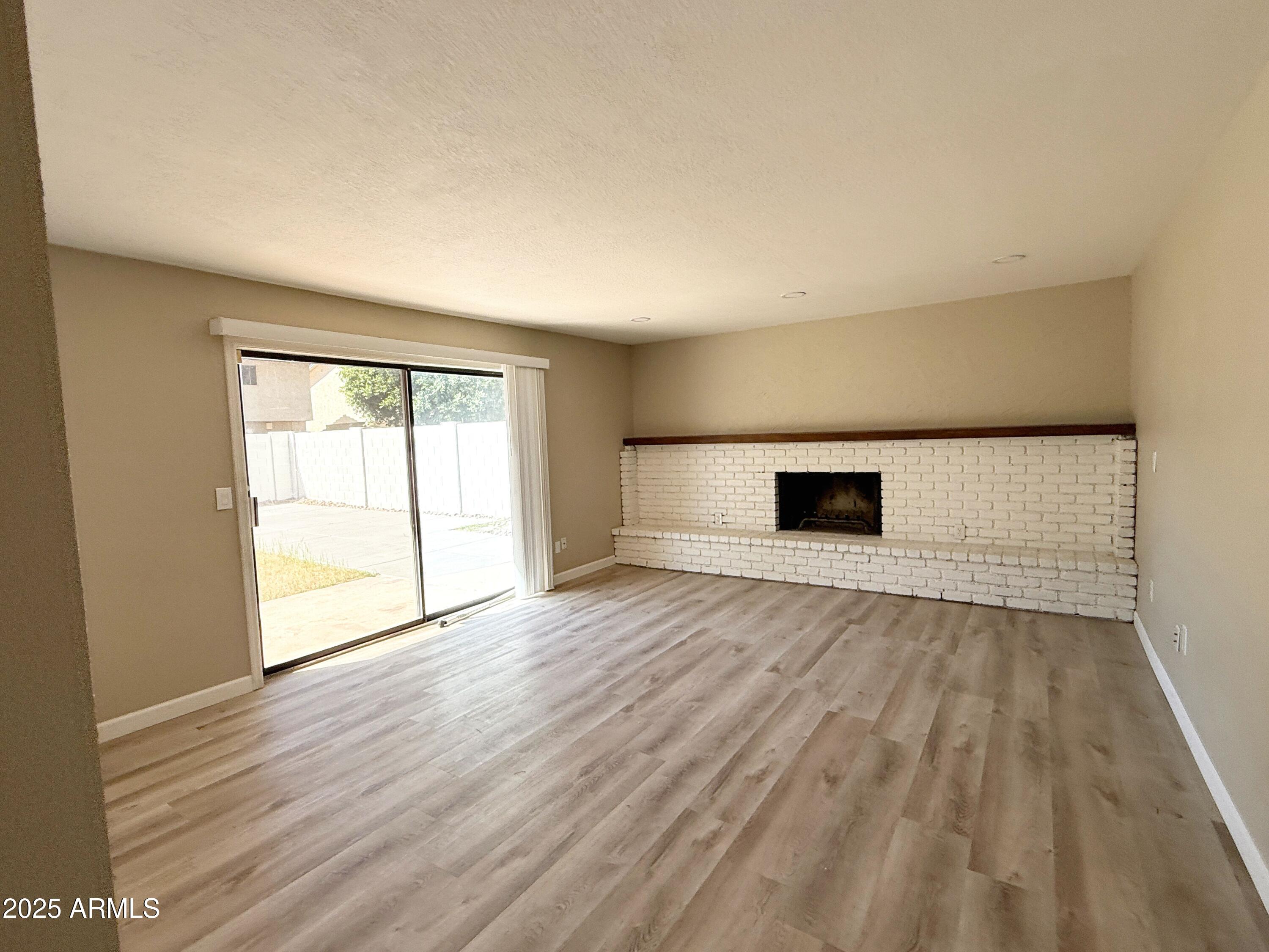1529 East Edgewater Drive Tempe, AZ 85283 - Photo 5 of 34 a view of empty room with wooden floor and fan