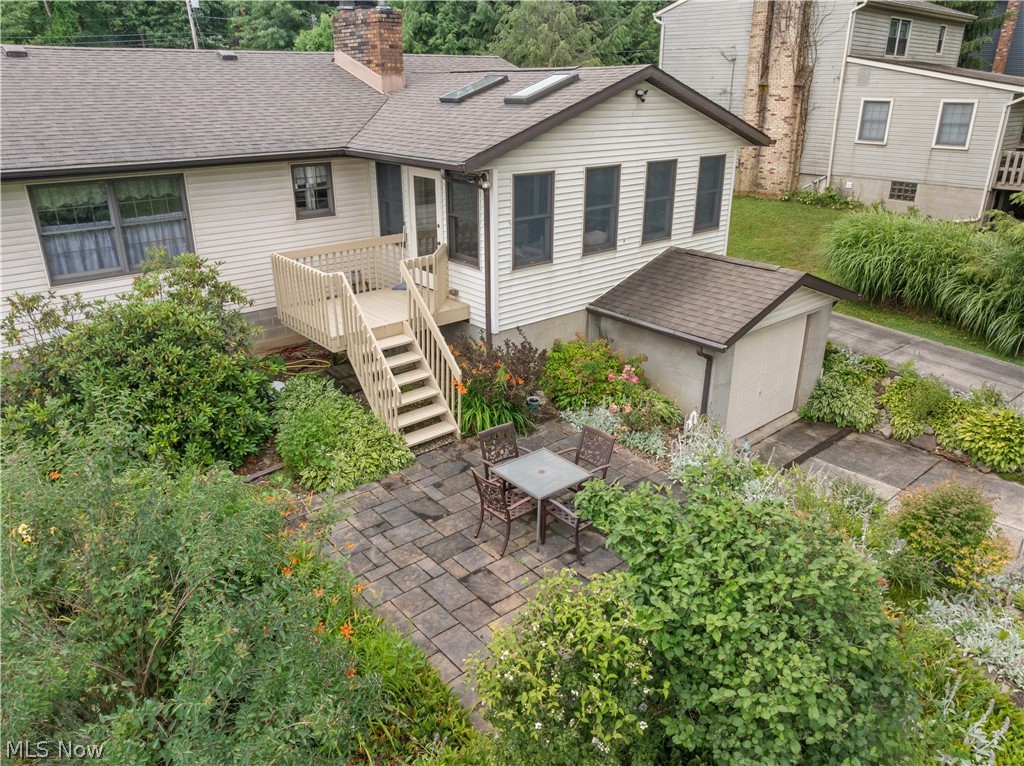 1835 Lynn Road Kent, OH 44240 - Photo 44 of 48 Expansive outdoor living area featuring a stone paver patio, mature landscaping, and a multi-level deck with stairs