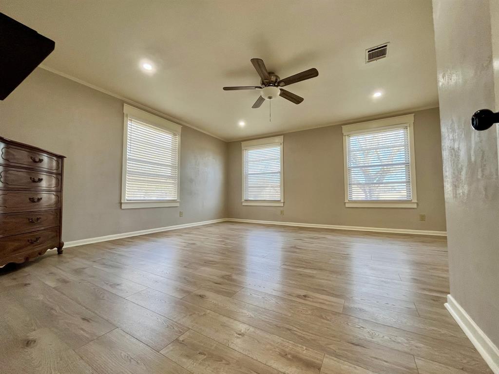 2802 Westover Road Shreveport, LA 71108 - Photo 12 of 33 a view of an empty room with wooden floor and a window