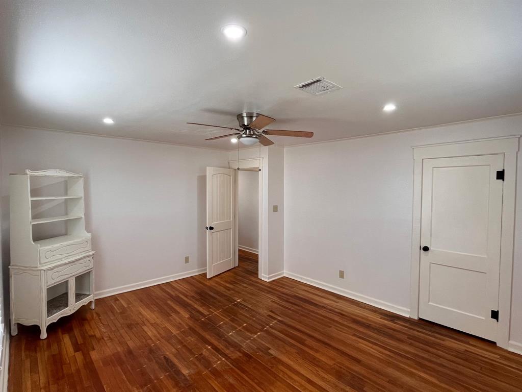 2802 Westover Road Shreveport, LA 71108 - Photo 21 of 33 a view of empty room with wooden floor and fan