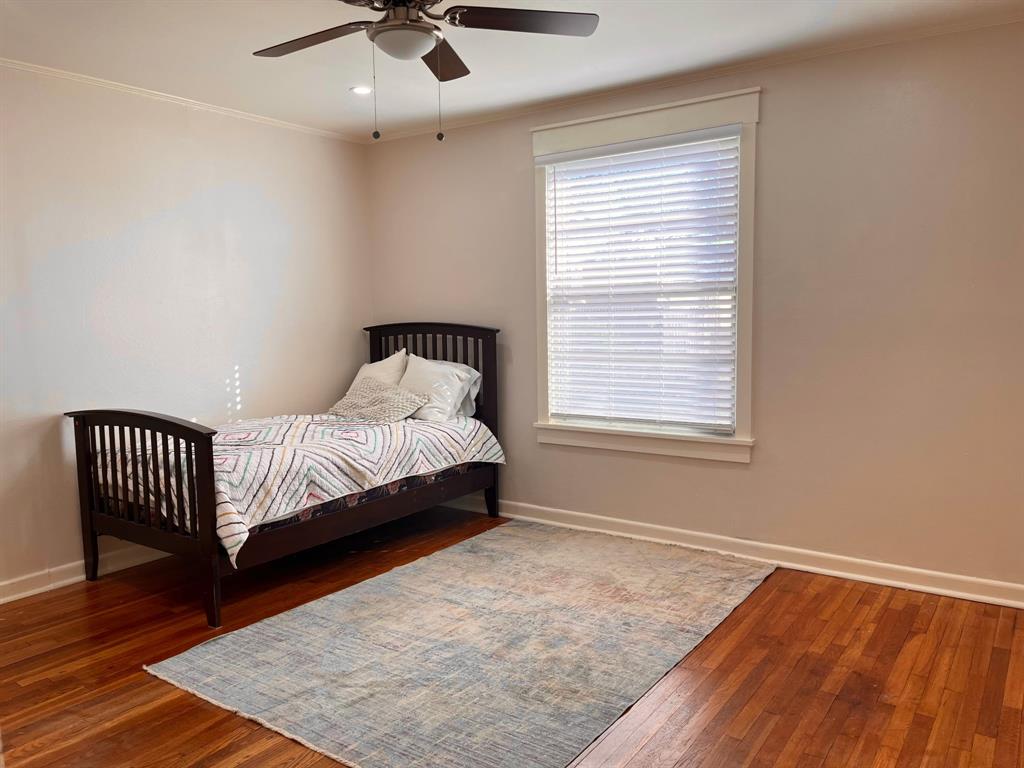 2802 Westover Road Shreveport, LA 71108 - Photo 22 of 33 a bedroom with a bed and wooden floor