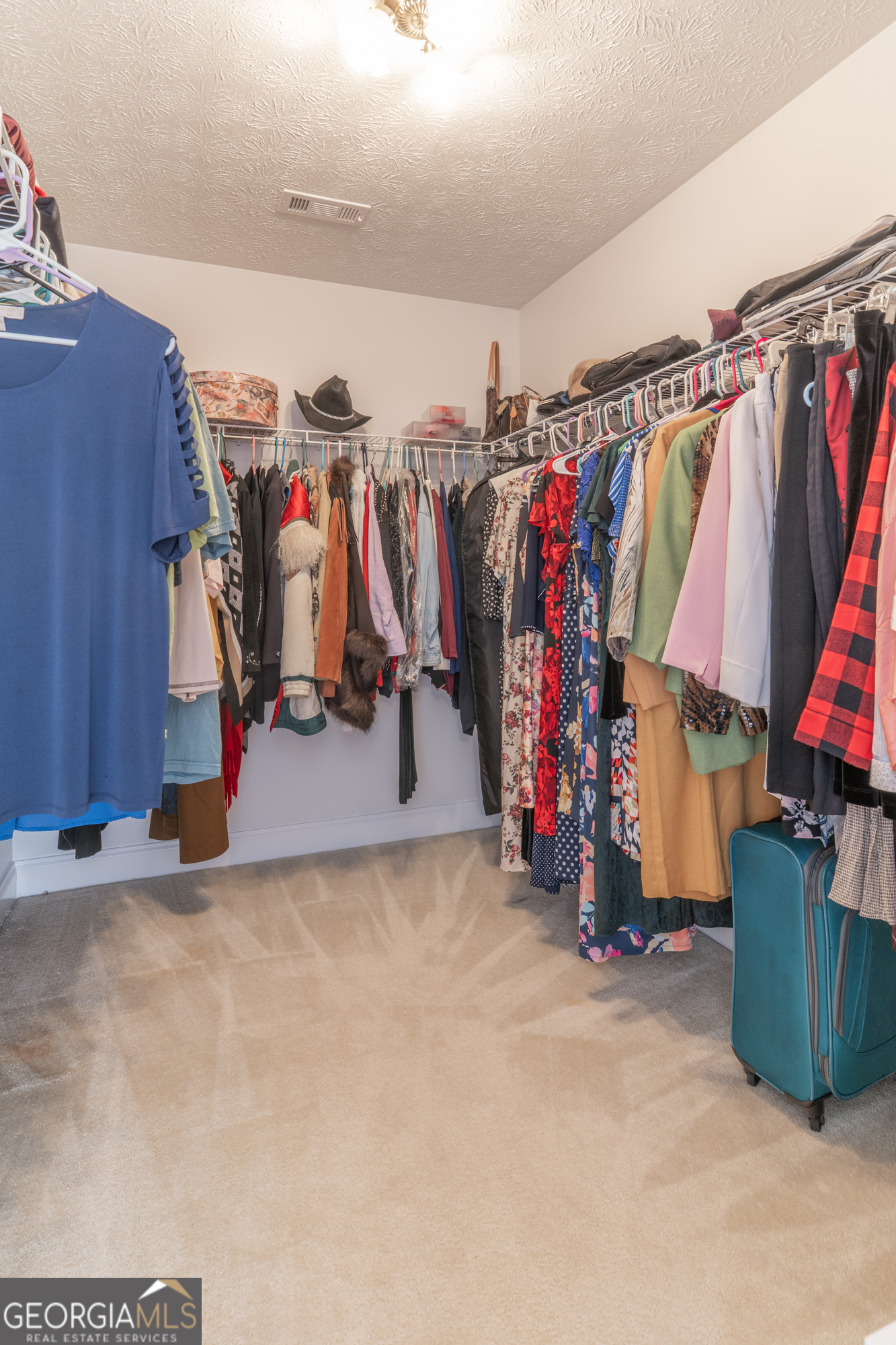 724 Teamon Road Griffin, GA 30223 - Photo 39 of 50 a view of walk in closet with clothes