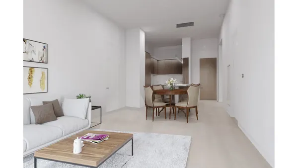 a living room with furniture and a dining table