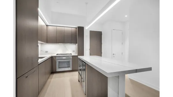 a kitchen with a sink cabinets and stainless steel appliances