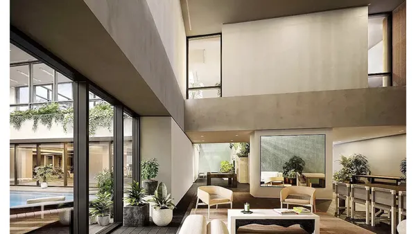 a living room with furniture and large windows