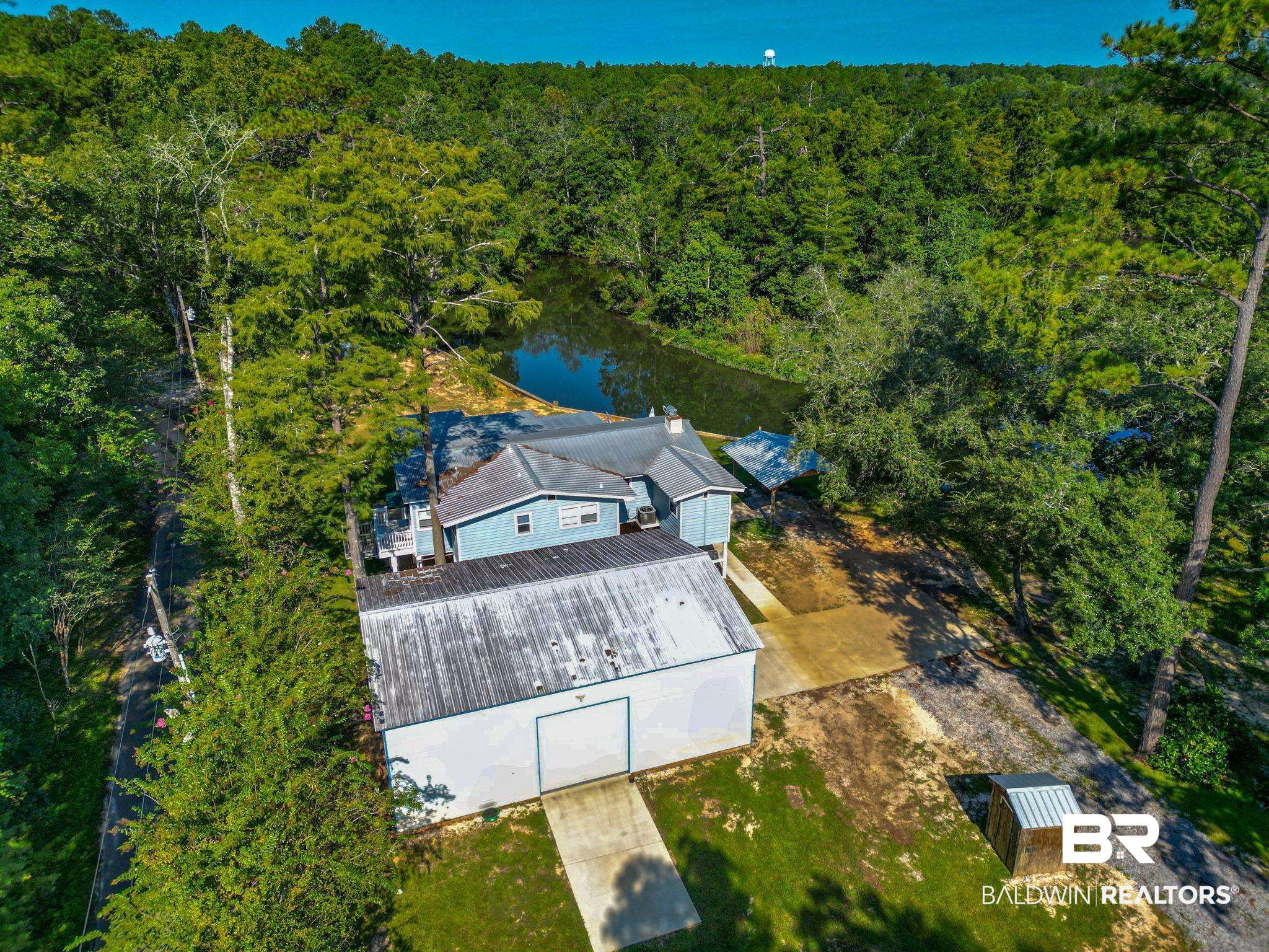 12855 Woodhaven Dairy Road West Silverhill, AL 36576 - Photo 27 of 27 View of subject property featuring a nearby body of water and a heavily wooded area