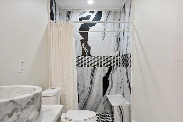 a bathroom with a sink toilet and shower