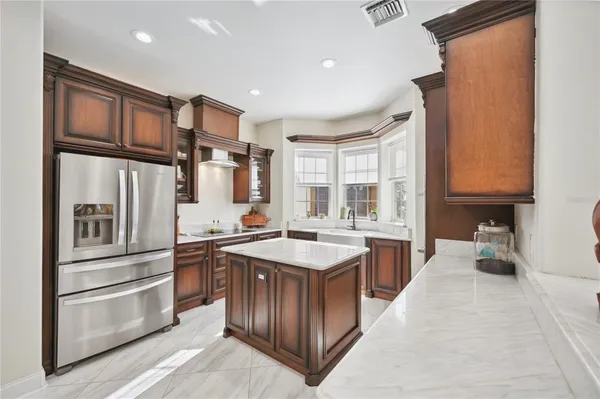 a kitchen with stainless steel appliances granite countertop a sink stove and refrigerator