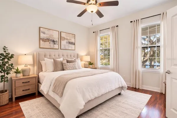 a bedroom with a large bed and a window