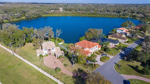 an aerial view of a house with backyard