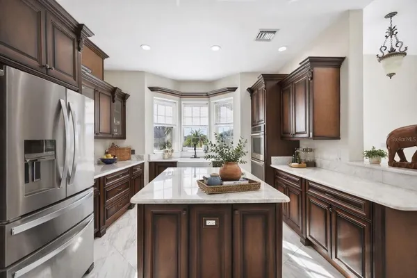 a kitchen with stainless steel appliances a sink stove and refrigerator